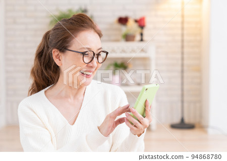 Senior woman watching smartphone Senior woman watching smartphone 94868780