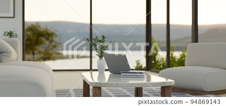 Modern and comfortable home living room with beautiful lake view through the window 94869143