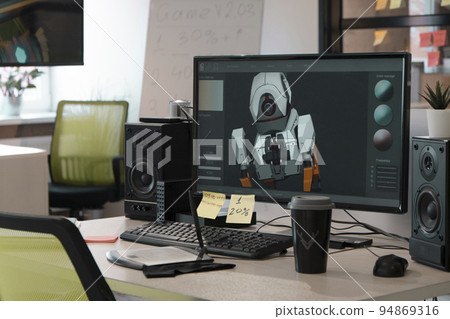 Designer's computer on table with a 3D model of a dog robot on a monitor screen Designer's computer on table with a 3D model of a dog robot on a monitor screen 94869316