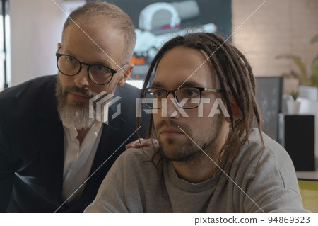 CEO and 3D artists discusses something and looks at monitor CEO and 3D artists discusses something and looks at monitor 94869323