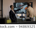 CEO of company studio developers of games discusses with the artist 3D model 94869325