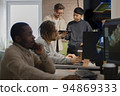 African American designer in draws on tablet 3D models for games. 94869333