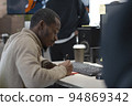 African American artist draws on tablet 3D model for computer game 94869342