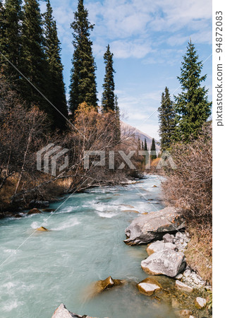 Glacial river flows through the Ala Archa mountain pass Glacial river flows through the Ala Archa mountain pass 94872083