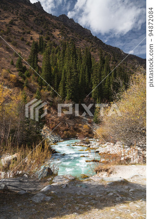 Glacial river flows through the Ala Archa mountain pass Glacial river flows through the Ala Archa mountain pass 94872084