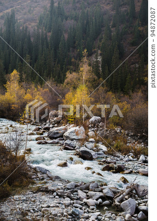 Glacial river flows through the Ala Archa mountain pass Glacial river flows through the Ala Archa mountain pass 94872087