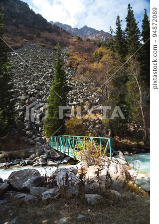 Glacial river flows through the Ala Archa mountain pass Glacial river flows through the Ala Archa mountain pass 94872089