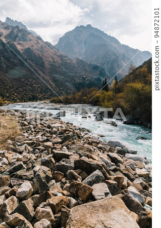 Glacial river flows through the Ala Archa mountain pass 94872101