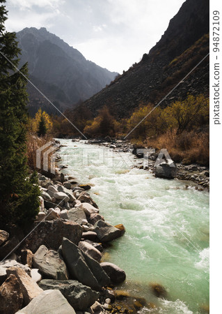 Glacial river flows through the Ala Archa mountain pass Glacial river flows through the Ala Archa mountain pass 94872109
