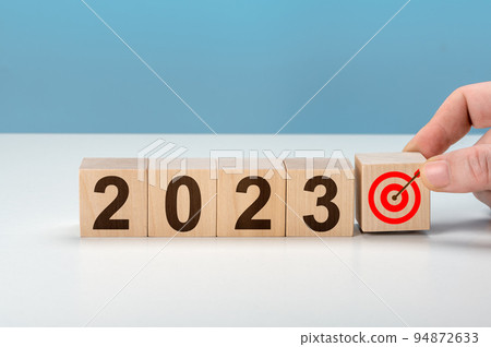 2023 goal. hand putting wooden cubes 2023 with goal icon on table and blue background, copy space. Start new year 2023 with goal plan. Starting to new year. Goals, plan, strategy, business, idea 94872633