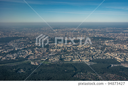 Aerial view photo from airplane of city and clear sky. aerial photo of large city from an airplane window. view of city through window from plane. aerial photography Aerial view photo from airplane of city and clear sky. aerial photo of large city from an airplane window. view of city through window from plane. aerial photography 94873427