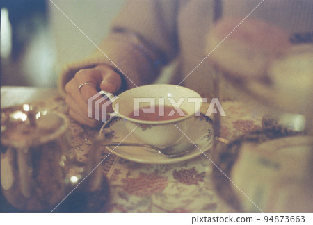 A woman enjoying tea time 94873663