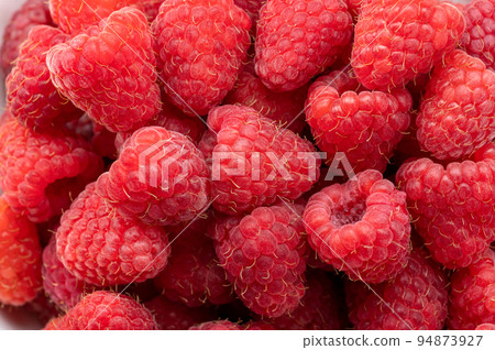 Fresh and sweet raspberries background. Fresh organic ripe raspberry. Bunch of red raspberries. top view Fresh and sweet raspberries background. Fresh organic ripe raspberry. Bunch of red raspberries. top view 94873927