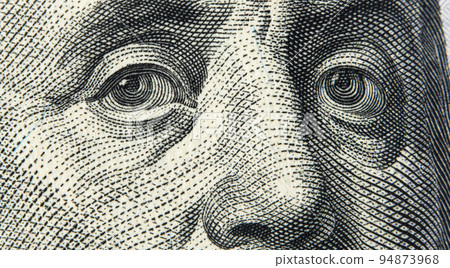 Close up view Portrait of Benjamin Franklin on one hundred dollar bill. Franklin eyes macro. 100 dollar bill with Benjamin Franklin eyes macro shot. 94873968