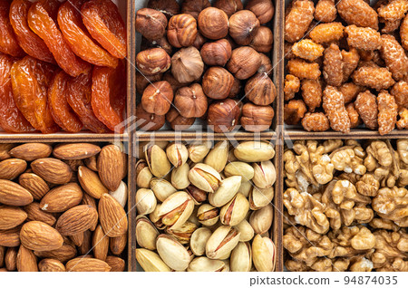 assorted dried fruits, nuts and seeds, top view. healthy food background. Different superfoods. Vegetarian snack of different nuts. organic mixed nuts background 94874035