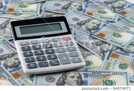 calculator on background of us dollars banknotes. Money dollars and calculator, economy concept, money distribution. crowdfunding. Business and financial concept 94874071