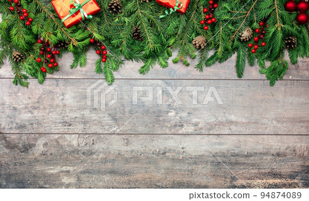 rustic wooden background with christmas ornaments. Christmas Holiday Evergreen Pine Branches and Red Berries Over Wood Background, Copy Space. Christmas rustic mockup 94874089