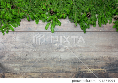 Christmas rustic background. Christmas winter holidays greeting template. Christmas tree branches and cones on dark wooden table with copy space. Christmas Dark rustic wood table with fir branches 94874094
