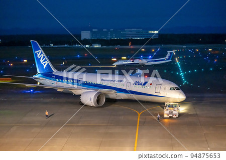 Airport at night Towing car pushing an airplane Chitose city, Hokkaido 94875653