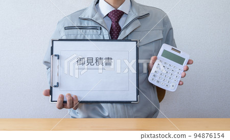 A man in work clothes presenting a quotation A man in work clothes presenting a quotation 94876154