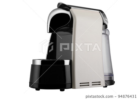 Beige electric capsule coffee machine with black inserts, modern design, diagonal arrangement, isolate 94876431