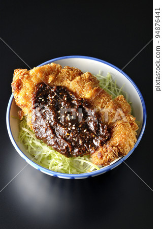 A bird's-eye view of a miso katsudon with plenty of cabbage on a black background A bird's-eye view of a miso katsudon with plenty of cabbage on a black background 94876441