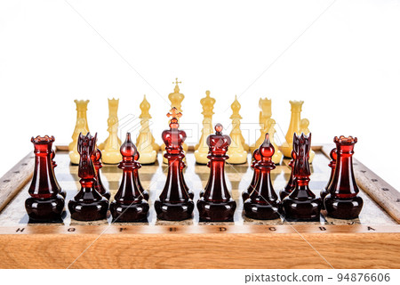 Natural amber different chess pieces figures standing on brown stone board. Close up game concept competition, Classic Gambit Tournament of confrontation. Natural amber different chess pieces figures standing on brown stone board. Close up game concept competition, Classic Gambit Tournament of confrontation. 94876606