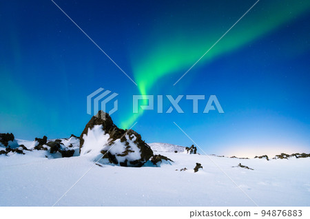 Aurora Borealis. Northern Lights over the mountains. A winter night landscape with bright lights.  94876883
