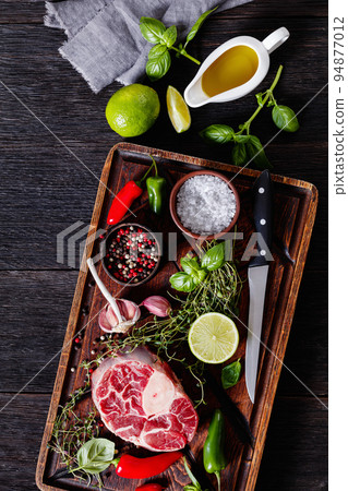 raw osso buco, veal shank steak on cutting board 94877012