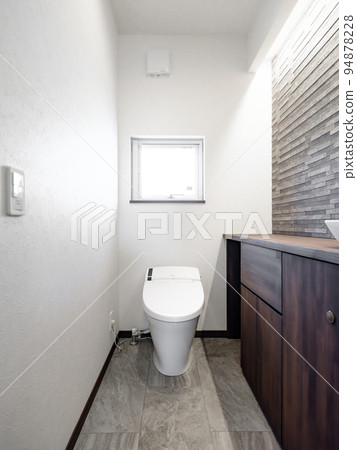 A toilet in a new house with a sleek and modern design 94878228