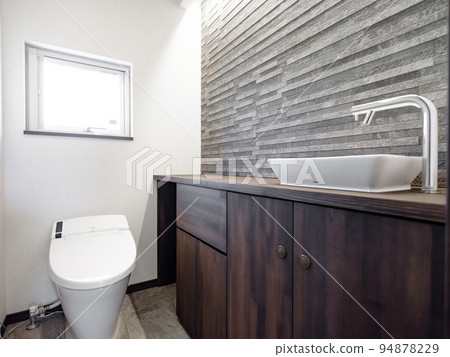 A toilet in a new house with a sleek and modern design 94878229