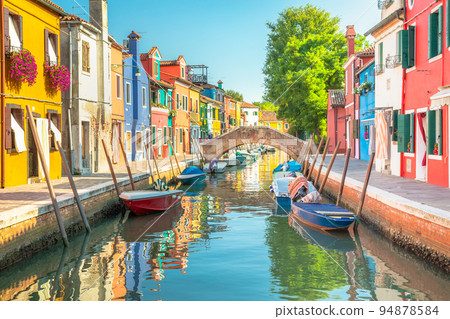 Burano island canal reflection, colorful houses and boats, Venetian lagoon Burano island canal reflection, colorful houses and boats, Venetian lagoon 94878584