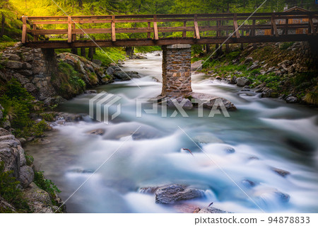Ethereal river and alpine meadows at springtime, Gran Paradiso Alps, Italy Ethereal river and alpine meadows at springtime, Gran Paradiso Alps, Italy 94878833