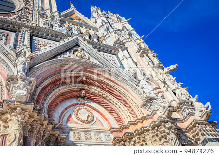 Medieval ancient and ornate cathedral at clear sky, Tuscany, Italy 94879276