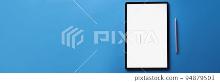 Set of black screen modern tablet device with reflection and silver pen on blue surface Set of black screen modern tablet device with reflection and silver pen on blue surface 94879501