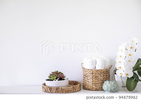 Potted plants in ecology straw baskets on shelf of bed linens cupboard textile arrangement storage 94879982