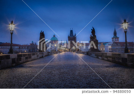 Charles bridge illuminated at dawn, Medieval Prague, Czech Republic 94880050