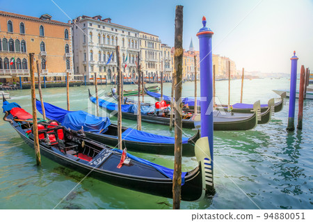 Ornate Gondolas in Grand Canal pier at sunrise, Venice, Italy Ornate Gondolas in Grand Canal pier at sunrise, Venice, Italy 94880051