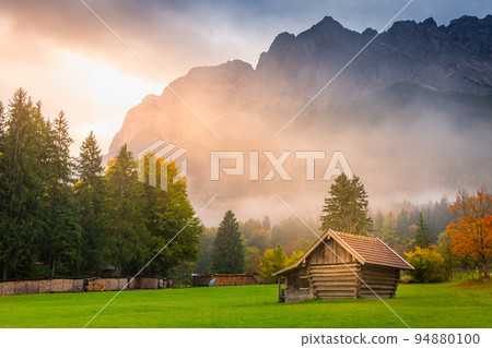 Bavarian alps autumn and wooden barn at sunset, Garmisch Partenkirchen, Germany Bavarian alps autumn and wooden barn at sunset, Garmisch Partenkirchen, Germany 94880100