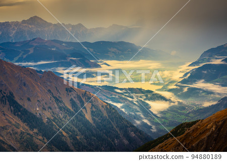 Misty valley from above Grossglockner and mountain landscape at dawn, Austria Misty valley from above Grossglockner and mountain landscape at dawn, Austria 94880189