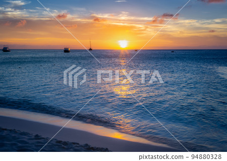 Aruba idyllic caribbean beach with boats at sunset, Dutch Antilles Sea Aruba idyllic caribbean beach with boats at sunset, Dutch Antilles Sea 94880328