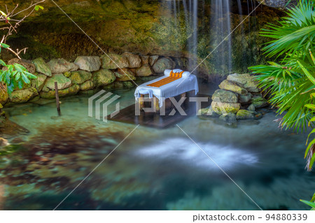 Massage Booth bed in a peaceful corner with lake and waterfall, Cancun, Mexico 94880339