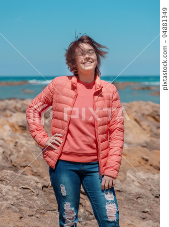 Happy Teenager girl wearing pink shirt and pudded jucket outdoor near the sea, mockup Happy Teenager girl wearing pink shirt and pudded jucket outdoor near the sea, mockup 94881349