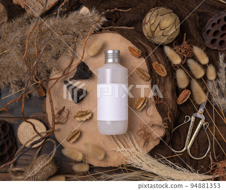 Cosmetic bottle on wood near natural boho decorations top view. Label Mockup Cosmetic bottle on wood near natural boho decorations top view. Label Mockup 94881353