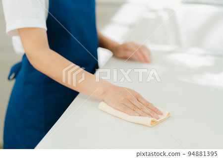 Housekeeper senior woman wiping 94881395