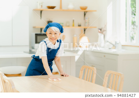 Housekeeper senior woman wiping 94881427