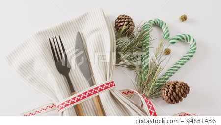 Image of christmas place setting with cutlery and copy space on white background Image of christmas place setting with cutlery and copy space on white background 94881436