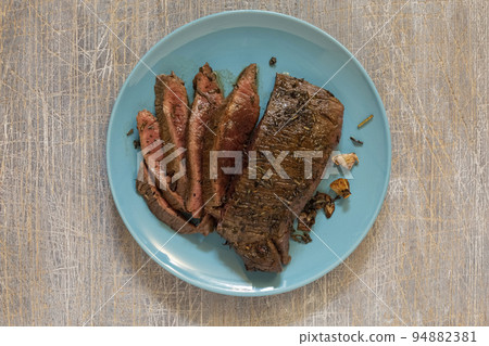 juicy steak with blood fried in a pan 94882381