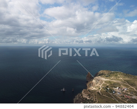 Abstract aerial nature summer ocean sunset sea and sky background. Small waves on clear water surface in motion blur with bokeh lights from sunrise. Holiday, vacation and recreational concept 94882404