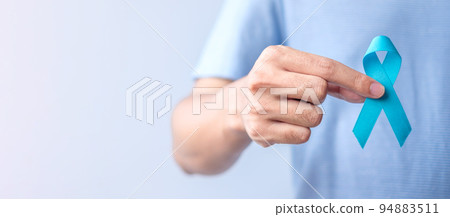 Blue November Prostate Cancer Awareness month, Man in blue shirt with hand holding Blue Ribbon for support people life and illness. Healthcare, International men, Father, Diabetes and World cancer day Blue November Prostate Cancer Awareness month, Man in blue shirt with hand holding Blue Ribbon for support people life and illness. Healthcare, International men, Father, Diabetes and World cancer day 94883511
